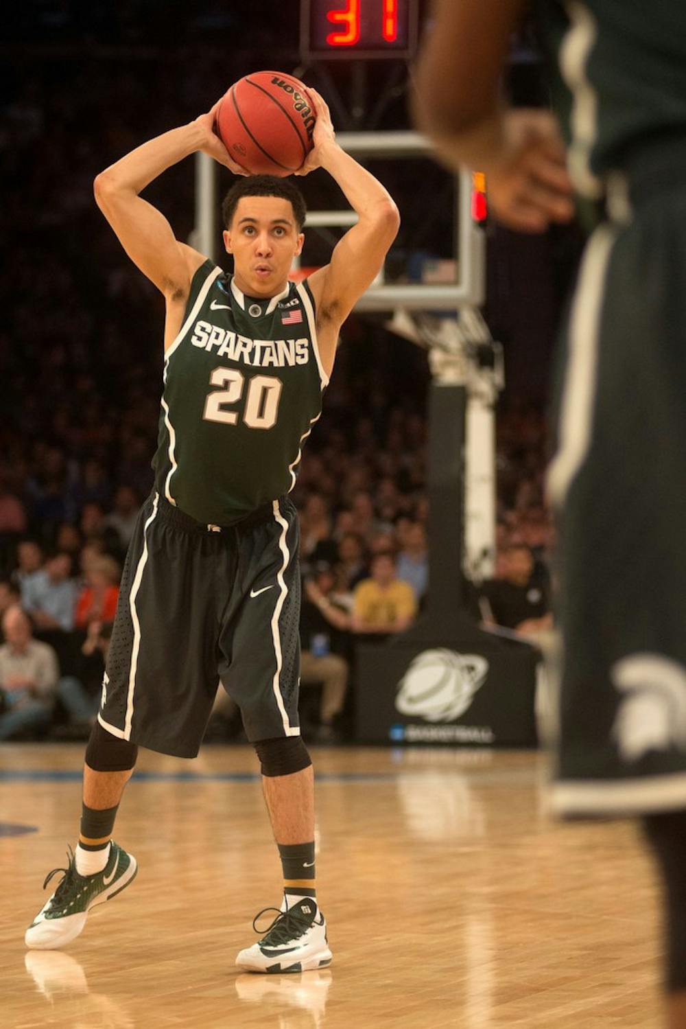 <p>Junior guard Travis Trice looks to pass March 28, 2014, during the game against Virginia at Madison Square Garden in New York City during the NCAA tournament. The Spartans won, 61-59. Julia Nagy/The State News</p>