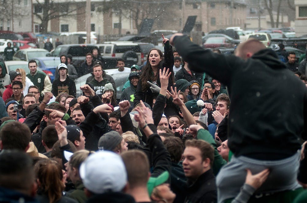 <p>Students celebrate the Spartan victory over Louisville March 29, 2015, at Cedar Village Apartments. The State News.</p>