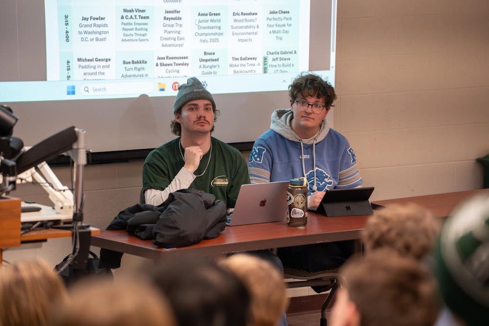 Patrick Coveyou, an senior applied engineering major and secretary of the Outdoors Club, sits with Chase Dannenberg, a senior majoring in geographic information science and the club’s treasurer, during a guest speaker presentation on Monday, Feb. 9, 2026, at IM West Recreational Facility in East Lansing, Mich.