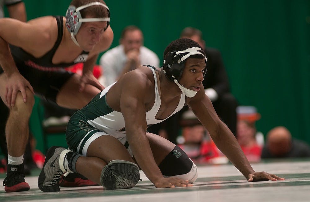 <p>Junior Terry Turner takes a defensive position during his match against Ohio State senior Logan Stieber Jan. 16, 2015, at Jenison Field House. The Spartans were defeated by the Buckeyes, 25-13. Alice Kole/The State News</p>