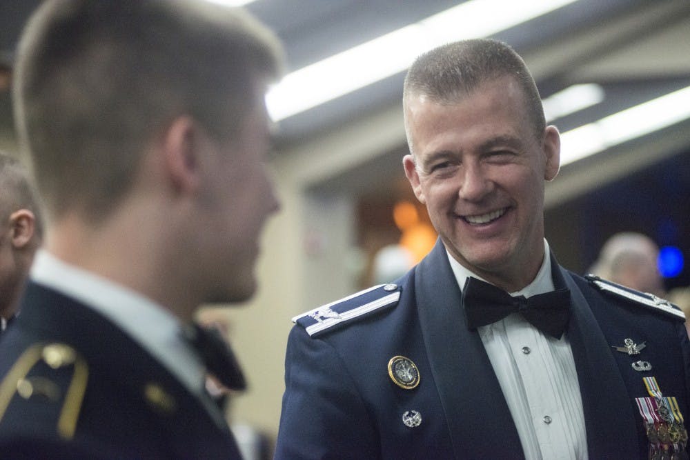 Airman T.J. Lincoln, right, laughs with his son sophomore ROTC Todd Lincoln, left, at the annual MSU Army ROTC Ball on Feb. 13, 2016 at Huntington Club, located on the fourth floor of Spartan Stadium.