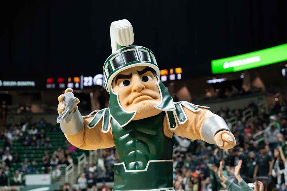 <p>Sparty goes to throw a t-shirt to a fan during the Spartan's victory over the Indiana Hoosiers on Dec. 29, 2022.</p>