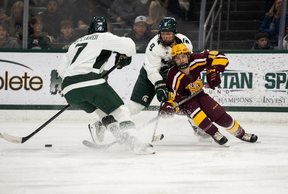 University of Minnesota player tries to get around the Spartans during a game at Munn Ice Arena on Dec. 2, 2022. The Spartans lost to the Gophers with score 5-0. 