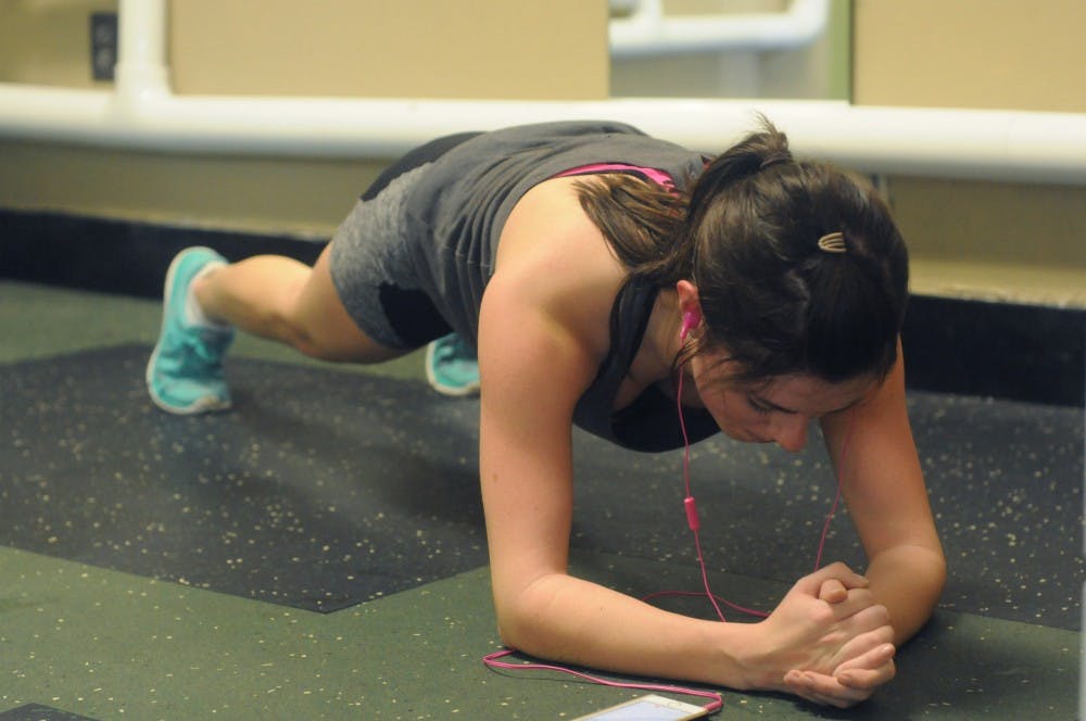 Education sophomore Heather Onak did a plank on Jan. 27, 2016 at Snyder-Phillips Hall. She stretched after running on the treadmill.