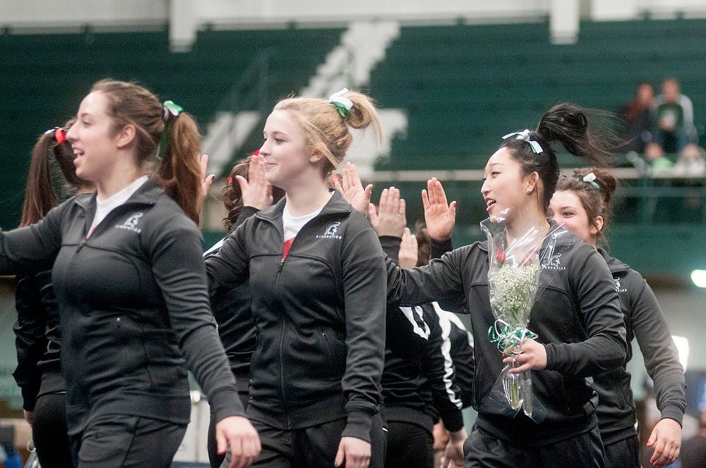 	<p>The <span class="caps">MSU</span> gymnastics team high fives the <span class="caps">OSU</span> gymnastics team after the meet on Feb. 16, 2013, at Jenison Field House. <span class="caps">OSU</span> beat <span class="caps">MSU</span> 195.575 to 194.25. Danyelle Morrow/The State News</p>