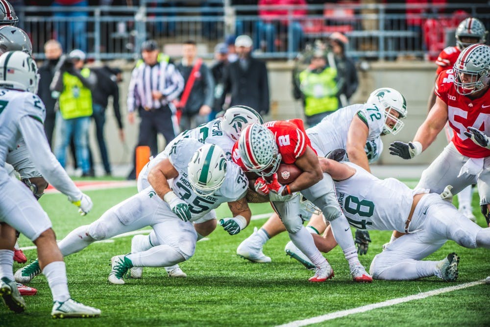 Ohio State running back J.K. Dobbins (2) is tackled during the game against Ohio State, on Nov. 11, 2017, at Ohio Stadium. The Spartans were defeated by the Buckeys, 48-3.