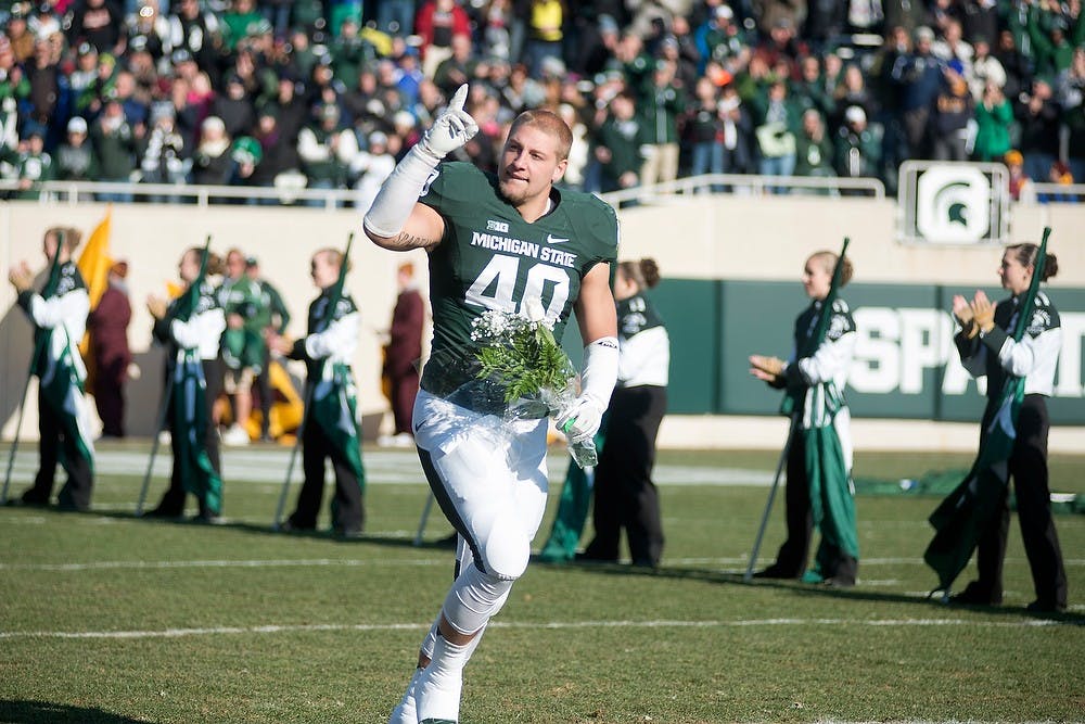 	<p>Senior linebacker Max Bullough runs to greet his family during Senior Day on Nov. 30, 2013, before the game against Minnesota at Spartan Stadium. The winningest senior class in Spartan history was honored before the crowd. Julia Nagy/The State News</p>