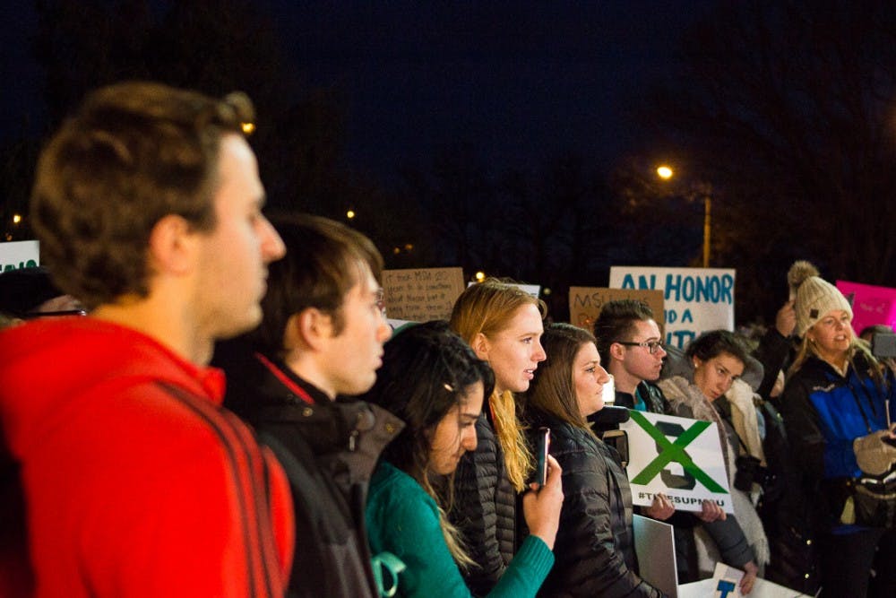 The crowd listens to the speakers on Jan. 26, 2018 at The Rock. The peaceful protest was organized by students in support of sexual assault survivors and demanding change from Michigan State University in the wake of the Nassar abuse scandal. 