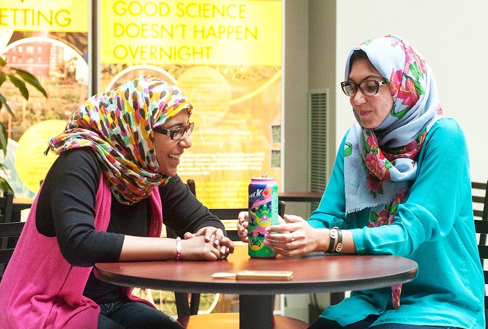	<p>Political science sophomore Hanan Murad, right, and communication freshman Loujain Hariri, left, take a break between classes Oct. 1, 2013, at the Morrill Hall of Agriculture lounge. Both international students recently moved from Saudi Arabia and are currently experiencing their first semester at Michigan State University. Irum Ibrahim/The State News</p>