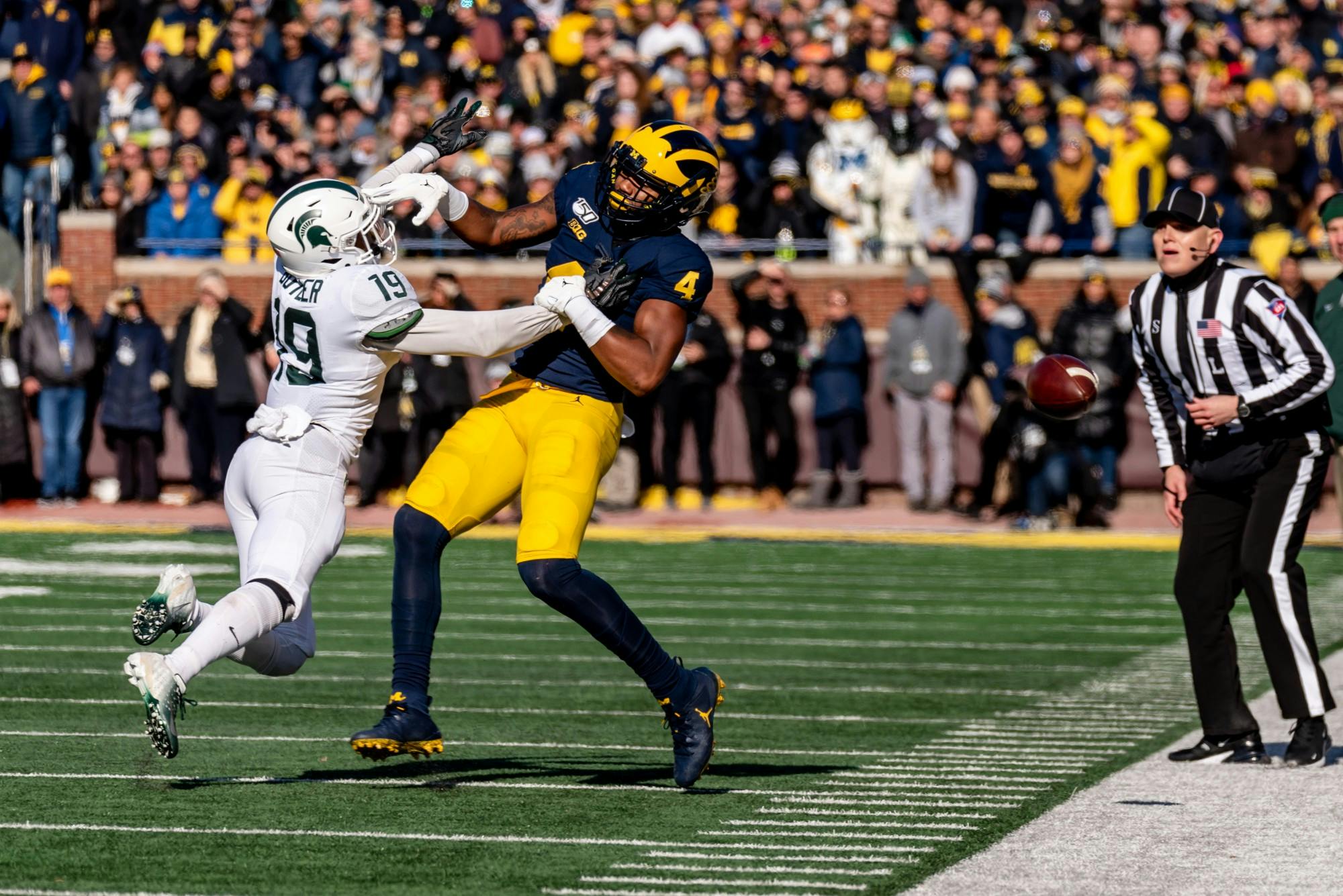 Senior corner back Josh Butler (19) tips a pass away from Michigan wide receiver Nico Collins (4). The Spartans fell to the Wolverines, 44-10, at Michigan Stadium on November 16, 2019. 
