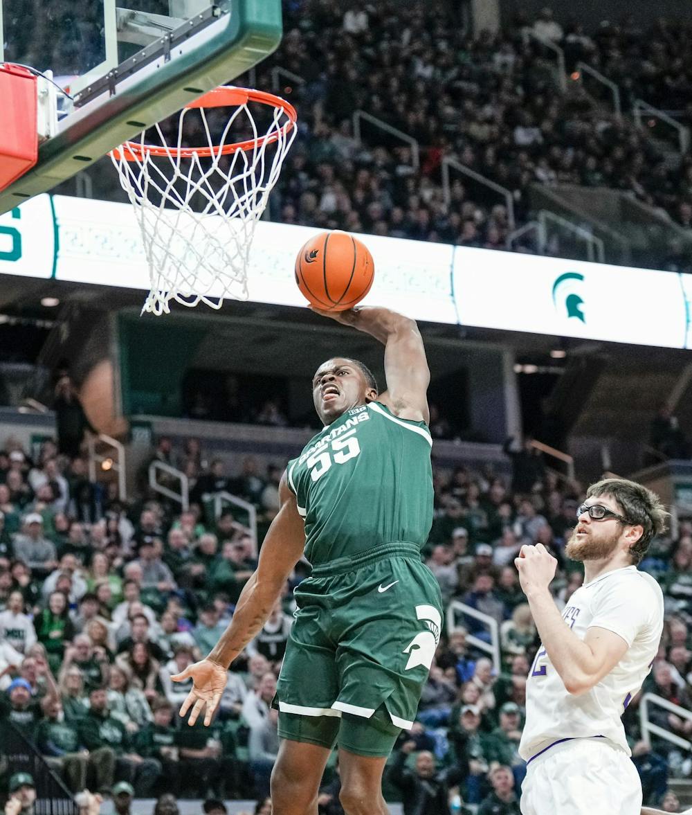 Michigan State sophomore forward Coen Carr (55) dunks the ball during a game against the University of Washington at the Breslin Center in East Lansing, Michigan on January 9, 2025. Michigan State won 88-54.