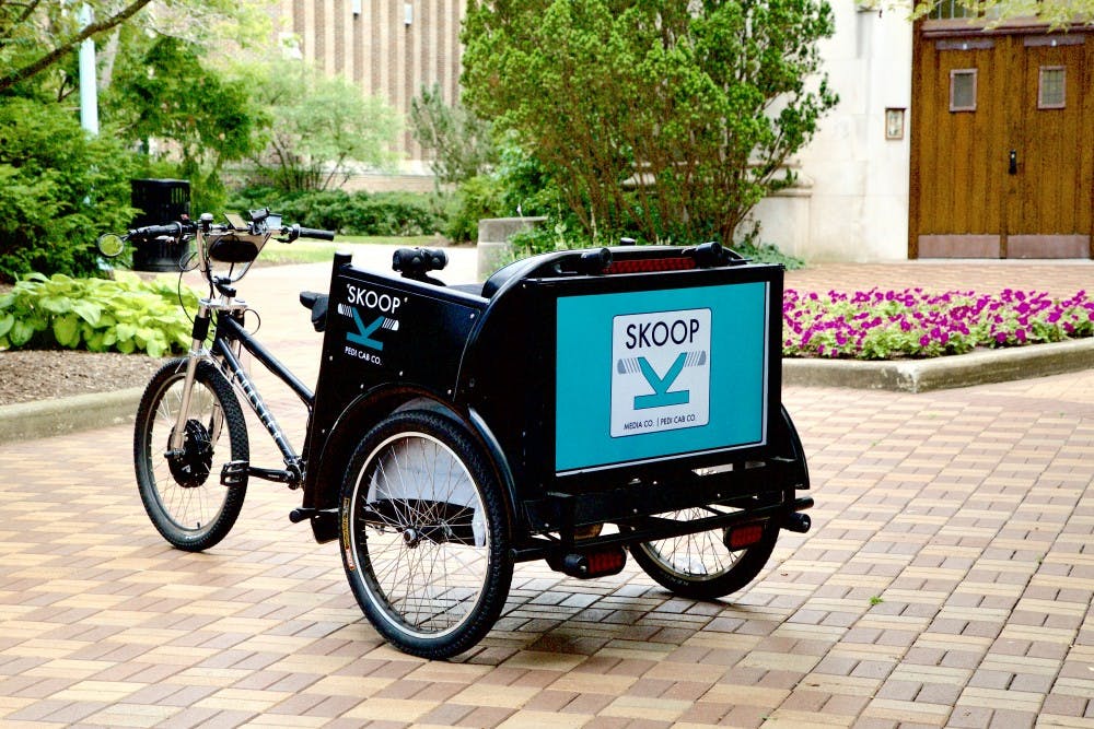 <p>One of the pedicabs used in advertising management sophomore Josh Cooper's Skoop transportation service. <strong>Photo courtesy of Skoop, Inc.</strong></p>