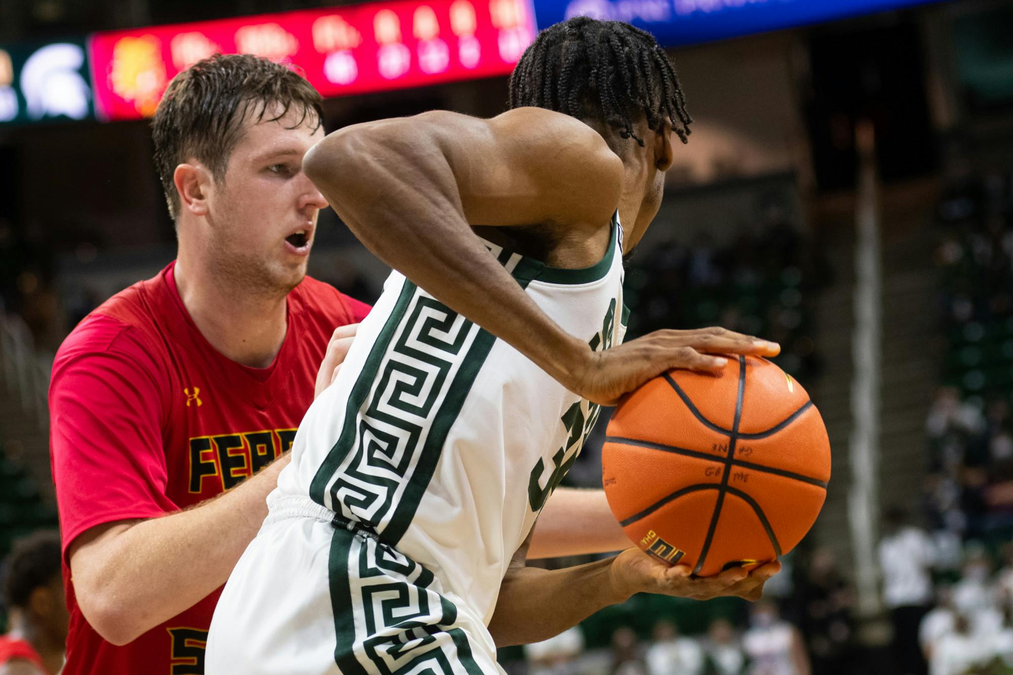 <p>Michigan State&#x27;s freshman forward Peter Nwoke (35) defends against Ferris State during Michigan State&#x27;s victory on Oct. 27, 2021.</p>