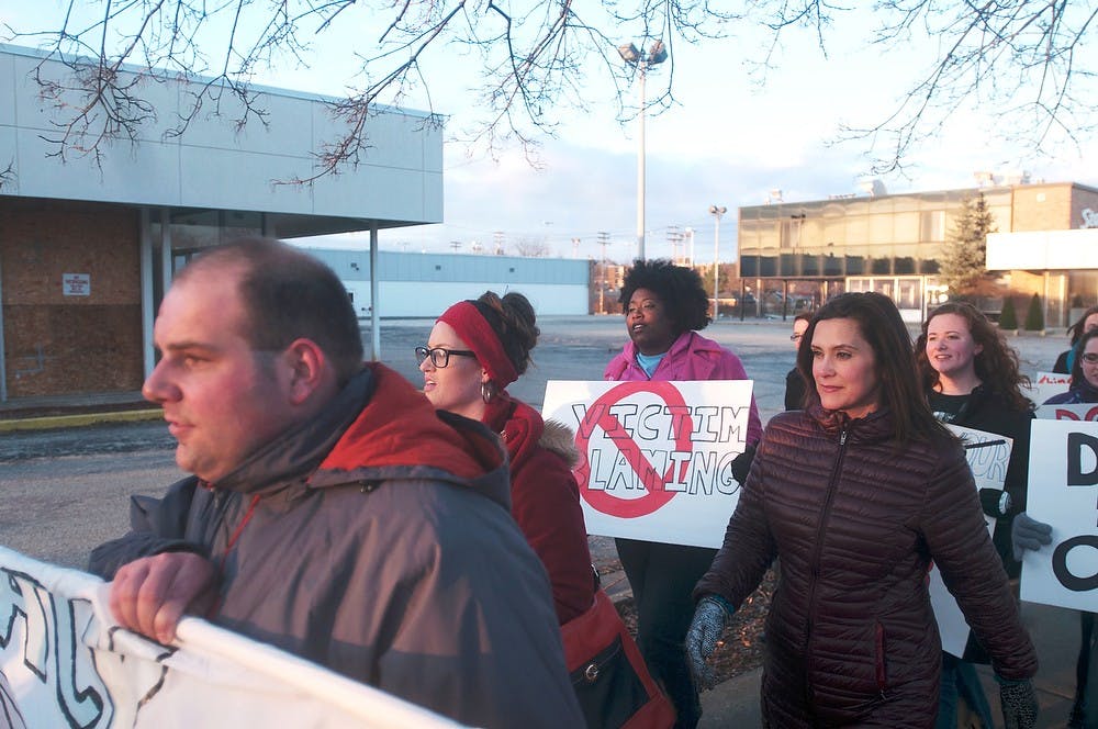 <p>Michigan state senator Gretchen Whitmer marches on April 15, 2014, on Michigan Ave. as part of "Take Back the Night." The event focuses on eliminating sexual violence. Betsy Agosta/The State News</p>