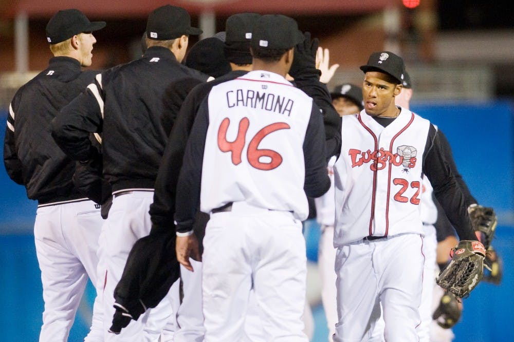 Lansing's outfielder Kenny Wilson congratulates with his teammates after victory against the Spartans on Thursday evening at Cooley Law School Stadium during Crosstown Showdown. Justin Wan/The State News