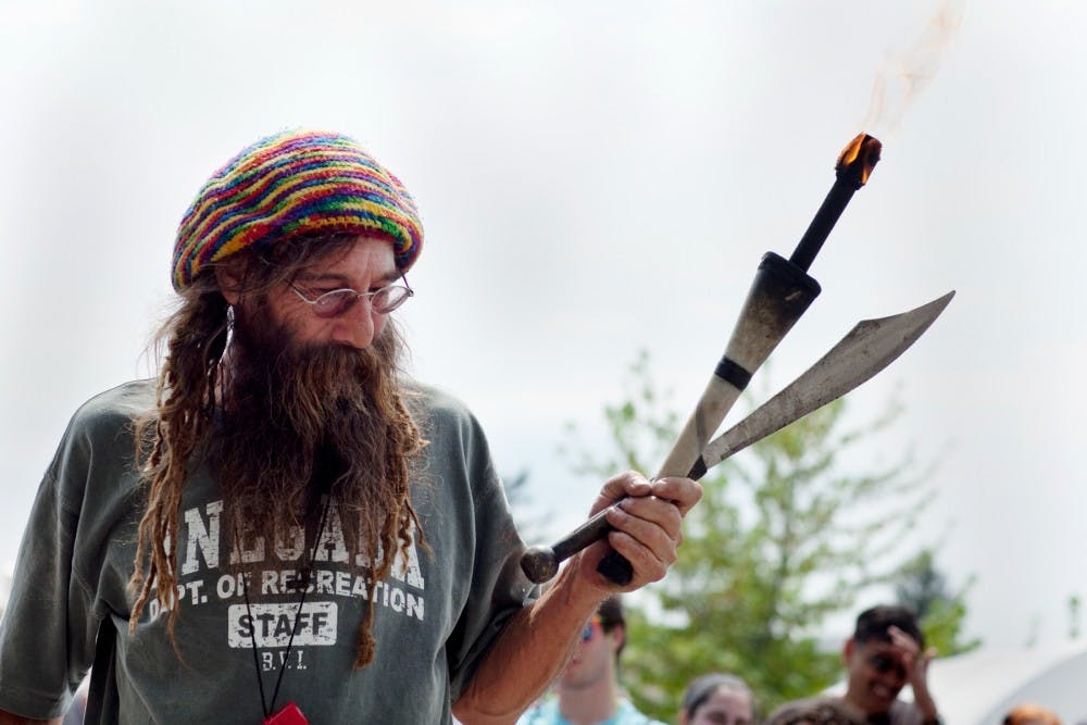 Street Performer Crazy Richard prepares to juggle torches and knives on May 20, 2011 at the 48th Annual East Lansing Art Festival. State News File Photo