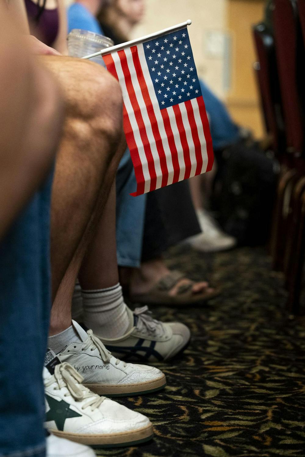 <p>A rally attendee holds an American flag at an Abdul El-Sayed rally at the MSU Union in East Lansing, Mich., on Sept. 11, 2026.</p>