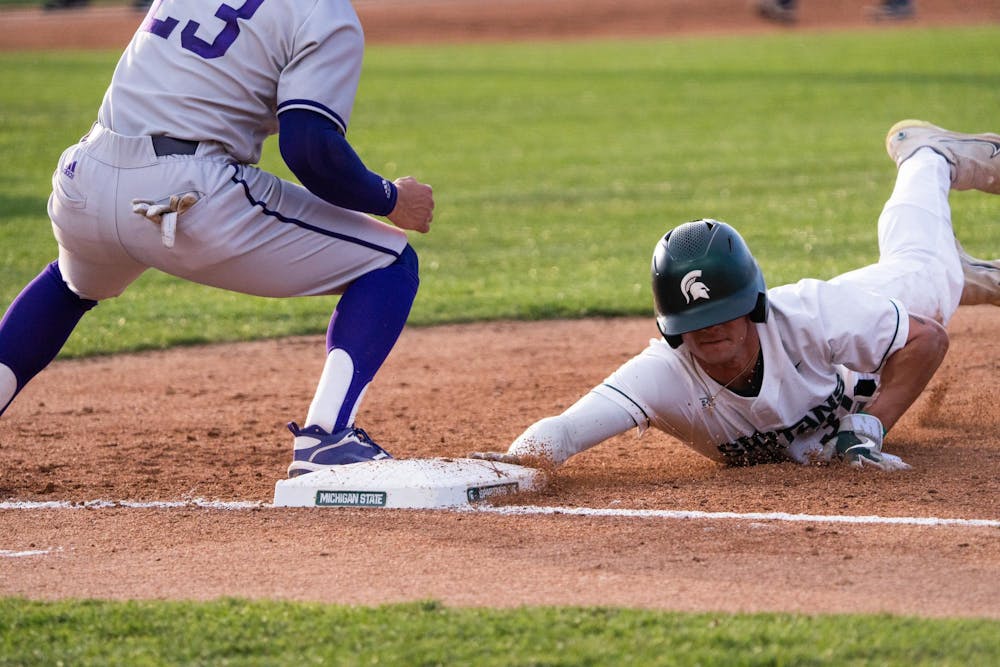 <p>MSU outfielder Greg Ziegler dives back to the bag after WIU pitcher Jake Armstrong attempted to pick him off at McLane Baseball Stadium on Friday, April 14, 2023. Armstrong threw to first several times in a long battle against the baserunner that culminated in him finally successfully picking Ziegler off. The call stood after review.</p>