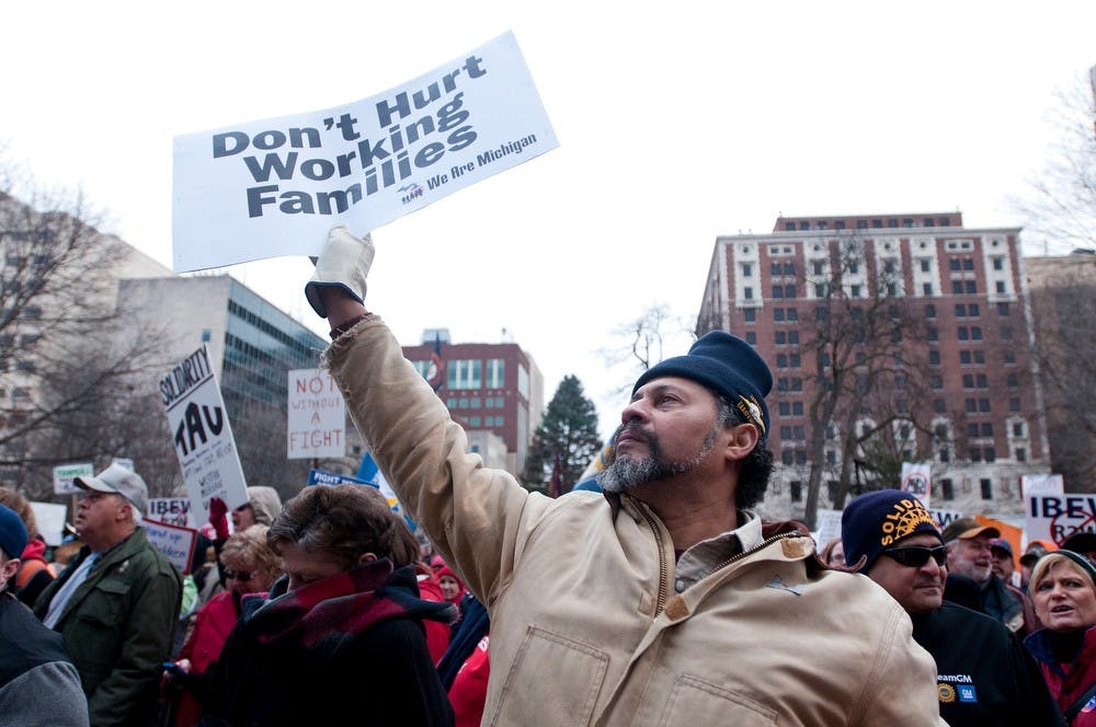 	<p>Kalamazoo, Mich. resident Jerome Roberts holds a sign stating his opinion about the right-to-work bill Tuesday, Dec. 11, 2012, at the Capitol during a protest. Roberts is a member of the local 131 Union. Katie Stiefel/ The State News</p>