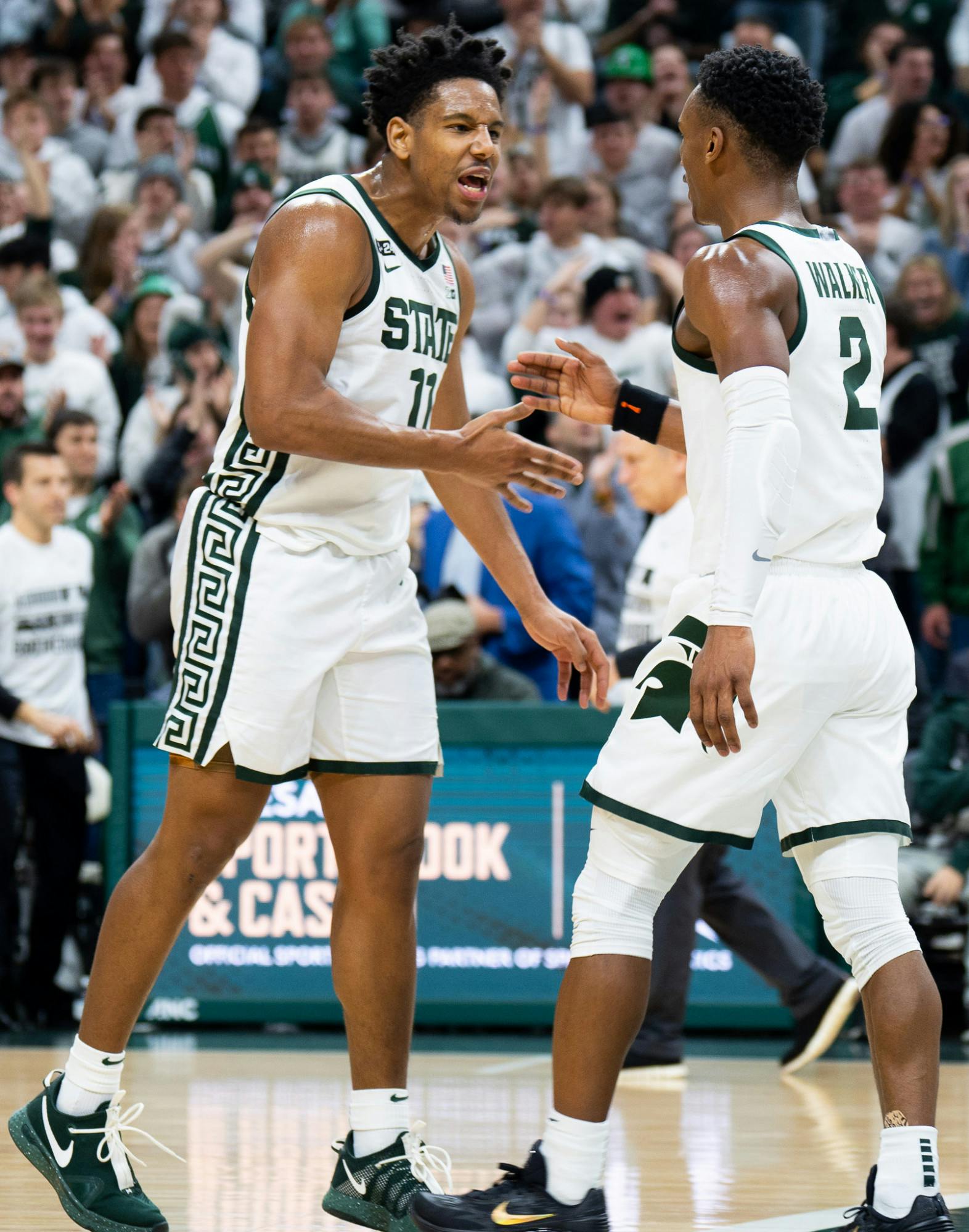 Junior guard AJ Hoggard (11) and senior guard Tyson Walker (2) celebrate after scoring against Purdue University at Breslin Center on Jan. 16, 2023. The Spartans fell to the Boilermakers with a score of 64-63. 