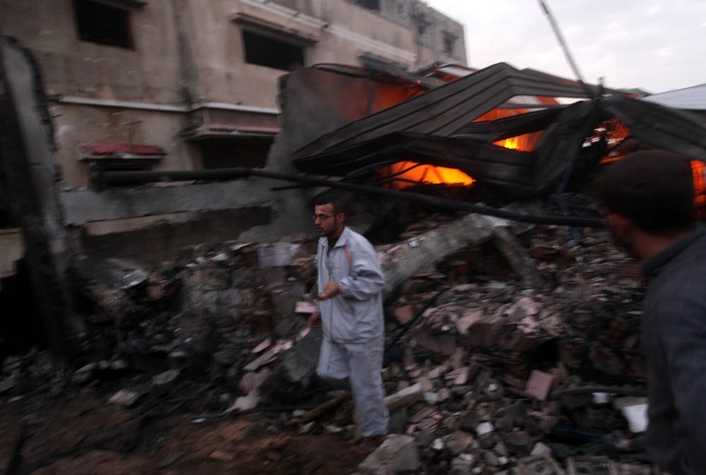 	<p>Palestinians try to extinguish a fire following an Israeli strike in Zeitun, on the outskirts of Gaza City, on Saturday, November 17, 2012. Israeli aircraft bombed Hamas government buildings in Gaza on Saturday, including the prime minister&#8217;s office, ahead of a possible ground invasion. (Ashraf Amra/APA Images/Zuma Press/MCT)</p>