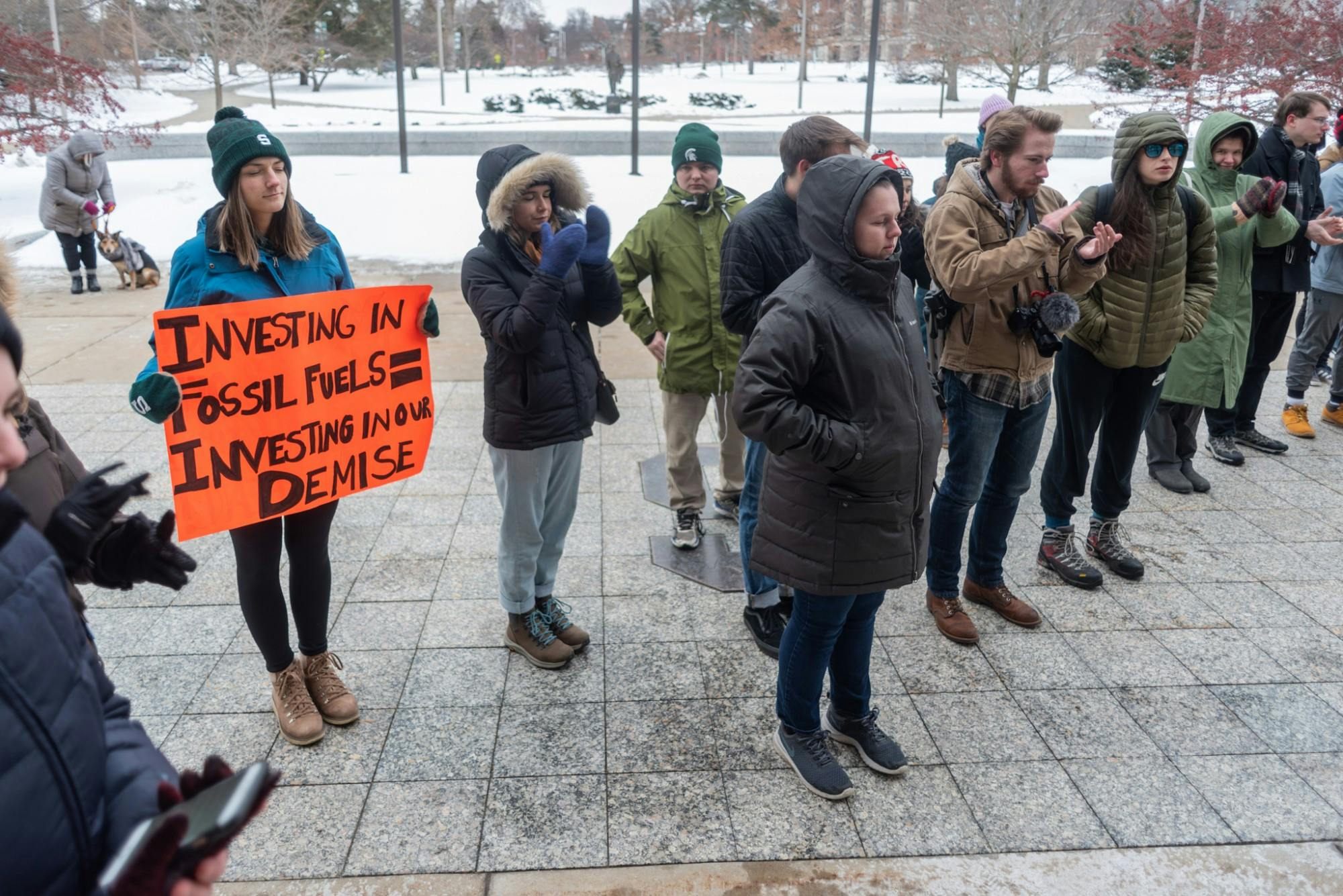 <p>Protesters applaud points made during a Divestment Day protest outside of the Hannah Administration Building on Feb. 14, 2020. </p>