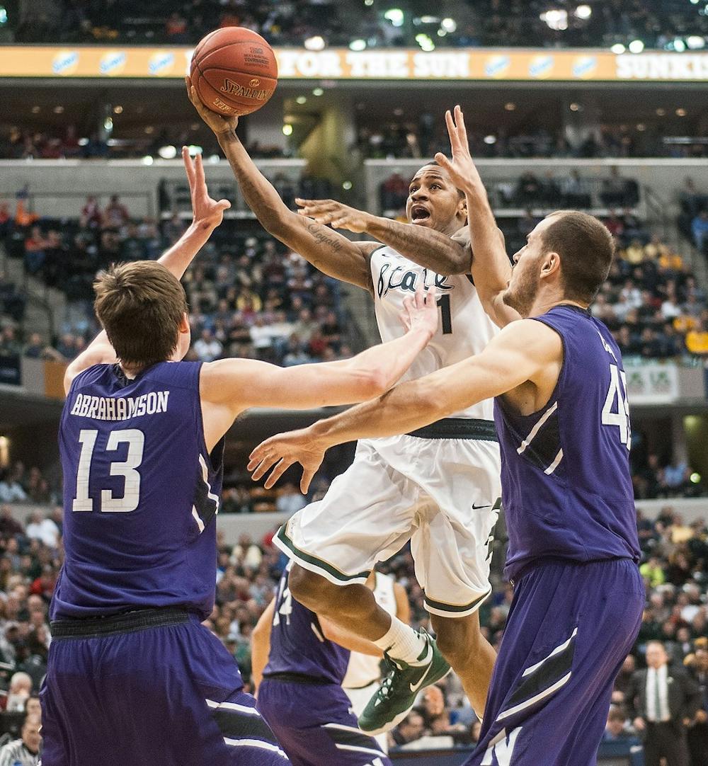 <p>Senior guard Keith Appling attempts a point over Northwestern forward Kale Abrahamson on March 14, 2014, at the Big 10 tournament in Indianapolis. At half time, the Spartans were beating the Wildcats, 40-22. Erin Hampton/The State News</p>