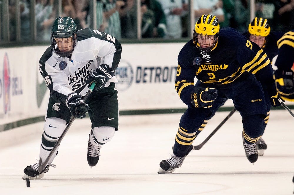 	<p>Sophomore forward Brent Darnell pushes the puck down the ice while Michigan forward Luke Moffatt skates after during a game on Saturday, Nov. 10, 2012 at Munn Ice Arena. Darnell assisted sophomore forward Matt Berry in scoring the first goal of the game. Julia Nagy/The State News </p>
