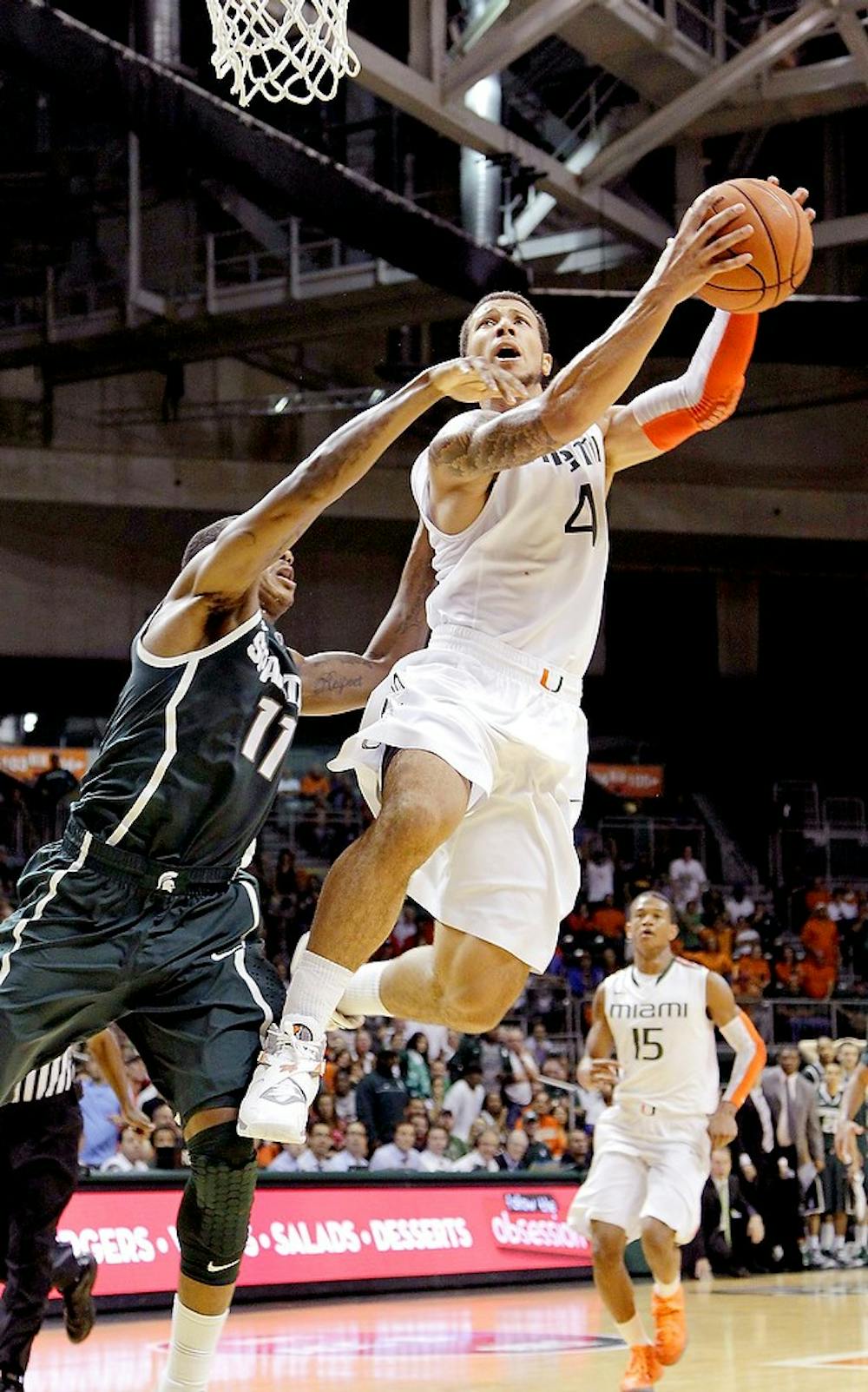	<p>Miami&#8217;s Julian Gamble, right, drives pass junior guard Keith Appling in the second half during Miami&#8217;s victory Wednesday. Carl Juste/Miami Herald/MCT</p>