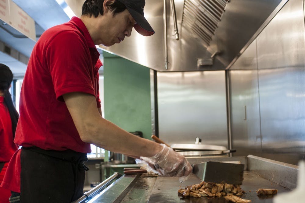Manager Jerry Lin cooks some chicken on the grill prior to the lunch rush on Feb. 16, 2018 at Hibachi Bowl. Hibachi Bowl is located at 547 E. Grand River Ave. (C.J. Weiss | The State News)