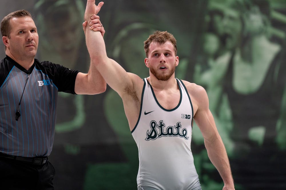 <p>Michigan State No. 11 senior Caleb Fish (17-4) celebrates his victory over No. 86 junior Anthony White (9-8) of Rutgers. Michigan State fell to No. 12 Rutgers 22-13, falling to 0-2 in conference play.</p>