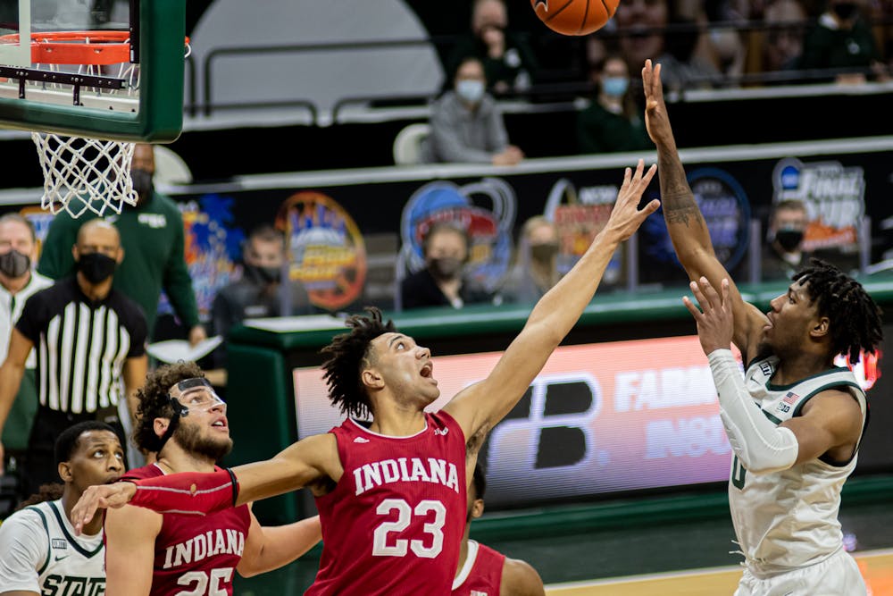 Junior guard Aaron Henry shoots a floater over Indiana's sophomore forward Trayce Jackson-Davis, during the Spartans' 64-58 win at the Breslin on March 2, 2021.