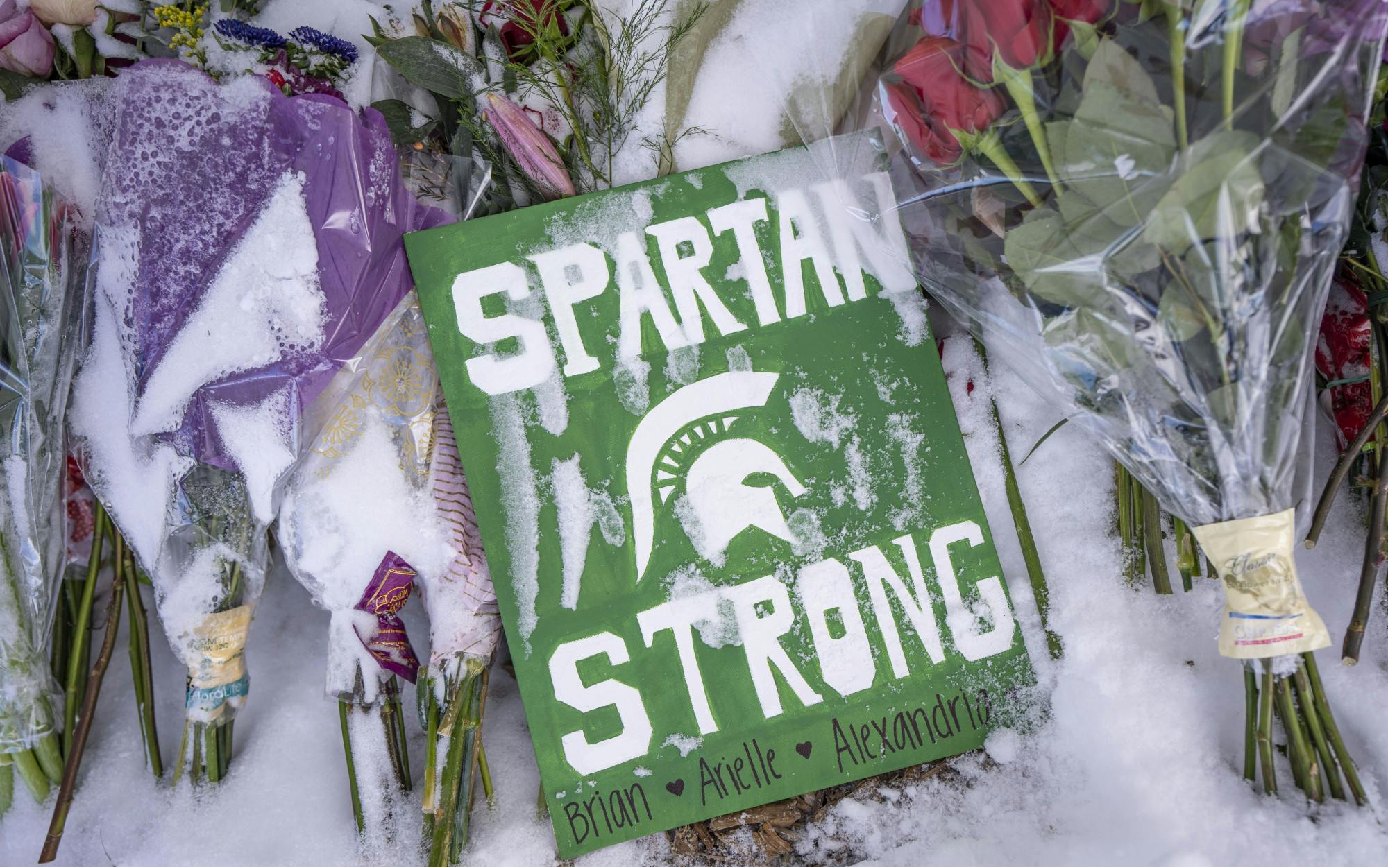 The memorial for Brian Fraser, Arielle Anderson and Alexandria Verner on Friday, Feb. 17, 2023, at the Rock on Farm Lane. Memorials started across campus after the three were killed and five more were critically injured by a mass shooting in MSU’s north campus on Feb. 13. 