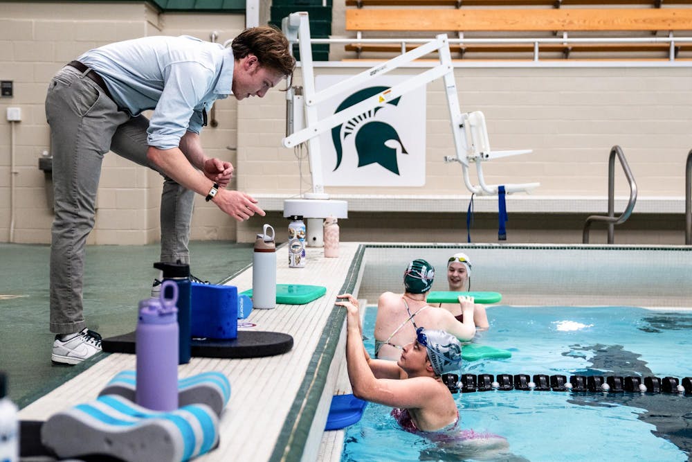 <p>Michigan State finance junior Zack Lezovich coaches a member of the Michigan State Swim Club during practice at the IM West Fitness Center on Michigan State University’s campus in East Lansing, MI on Tuesday, April 7, 2026.</p>