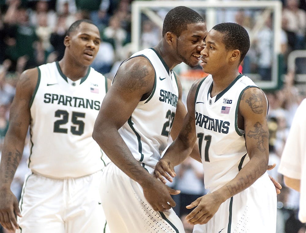 	<p>Sophomore guard/forward Branden Dawson talks with junior guard Keith Appling after helping him up from the floor. <span class="caps">MSU</span> defeated Michigan, 75-52, Tuesday, Feb. 12, 2013, at Breslin Center. Justin Wan/The State News</p>