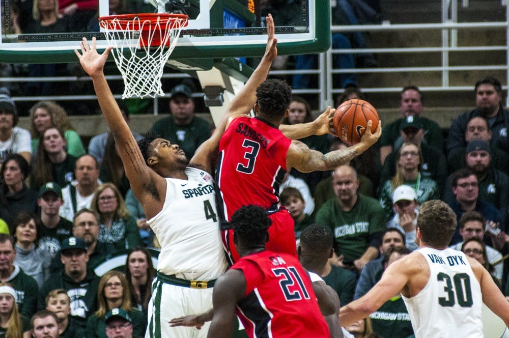 Freshman forward Nick Ward (44) covers Rutgers guard Corey Sanders (3) during the first half of the men's basketball game against Rutgers on Jan. 4, 2017 at Breslin Center.