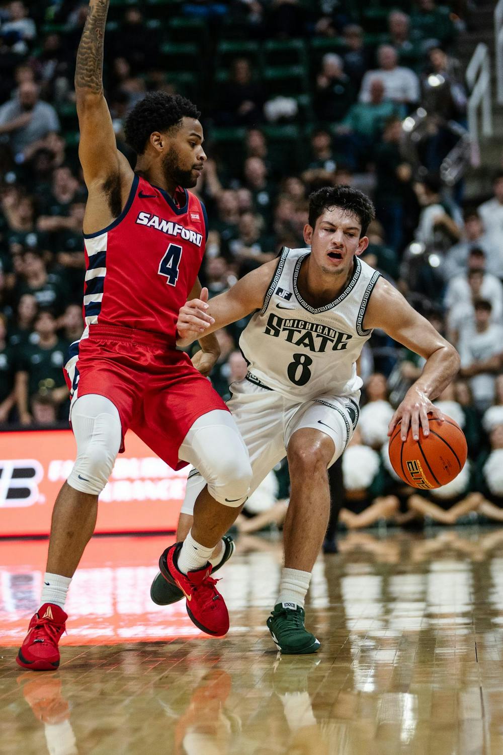 Michigan State senior forward Frankie Fidler (8) fights to keep the ball from Samford sophomore guard Isaiah West (4) at the Breslin Center on Nov. 19, 2024. The Spartans took on the Bulldogs of Samford University for the first time ever, ultimately defeating them 83-75. 