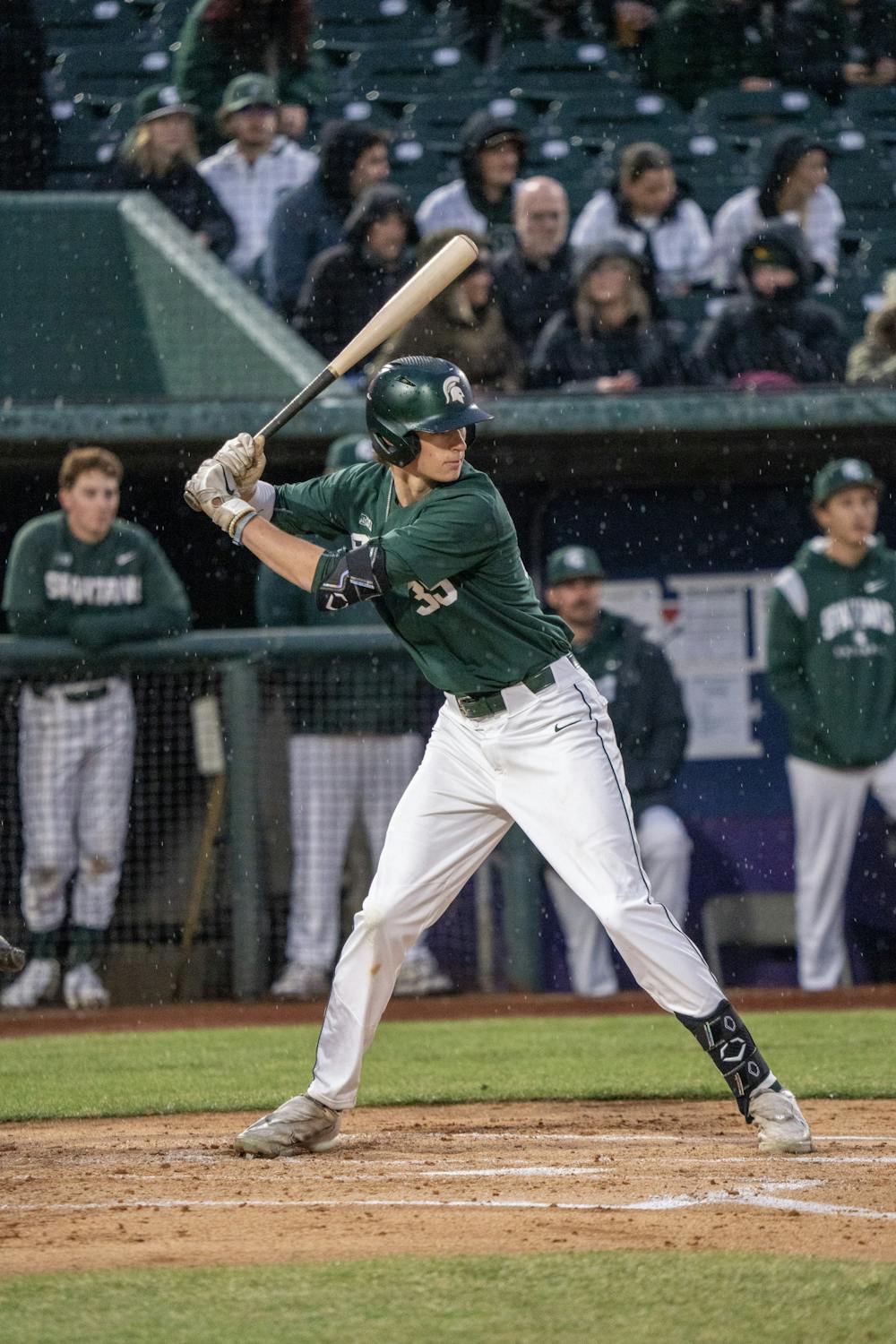 <p>Spartan senior off fielder Casey Mayes plays through the rain during the Crosstown Showdown in Lansing on April 4, 2023.</p>