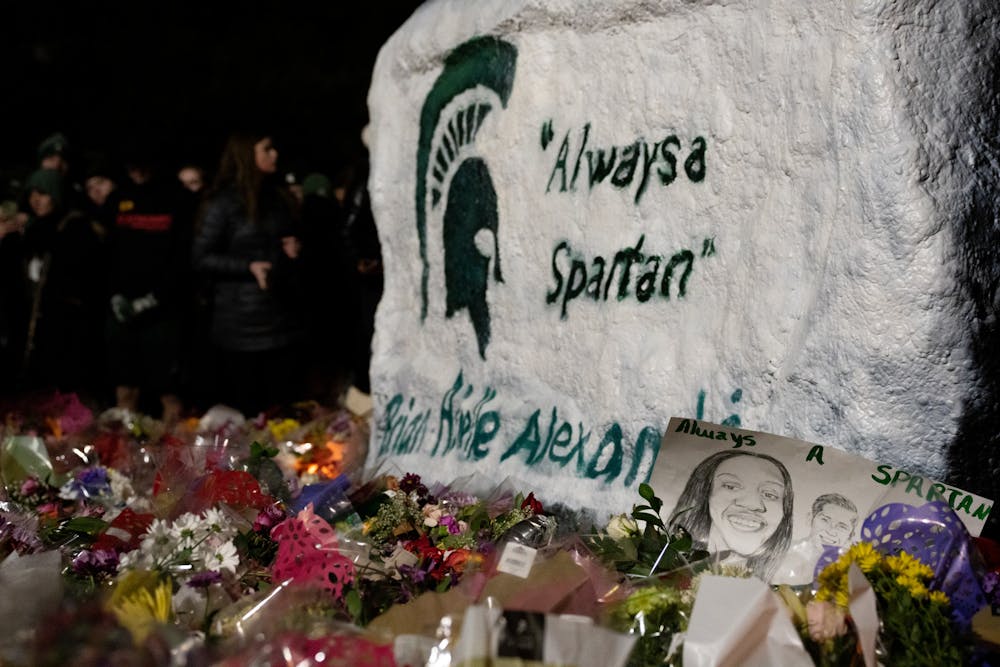 Thousands gather at the Rock on Farm Lane for a vigil that took place on campus on Feb. 15, 2023. Michigan representatives, MSU President Theresa Woodruff and MSU ASMSU President Jo Kovach were some of the speakers that expressed their sympathy for the victims,  injured and MSU community. 