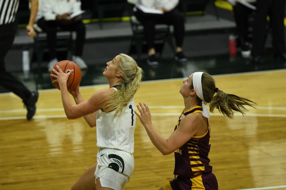 <p>Michigan State guard/forward Tory Ozment drives into the middle of the paint against Central Michigan on Dec. 18, 2020 at the Breslin Center.</p>