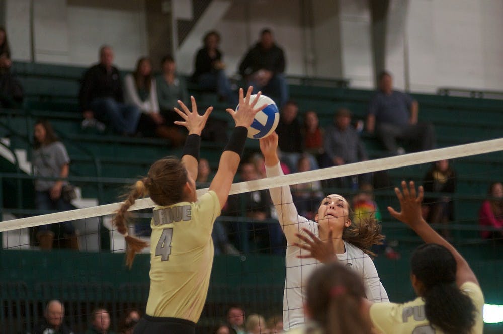 <p>Sophomore middle blocker/ opposite hitter Allyssah Fitterer spikes the ball over Boilermaker outside hitter Sam Epenesa Nov. 26, 2014 during the game against Purdue at Jenison Field House. MSU defeated the Boilermakers, 3-0. Dylan Vowell/The State News</p>