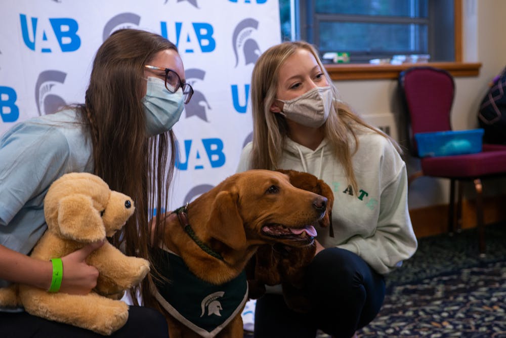 <p>Business-preference freshman Jenna Hemmes (left) and packaging senior Anna Breitbarth (right) got to meet Zeke and create their own wonder dog at the UAB&#x27;s Zeke and Greet event. &quot;I&#x27;m officially in love and we met Zeke, so it&#x27;s been a good day,&quot; Hemmes said. Sept. 29, 2021.</p>