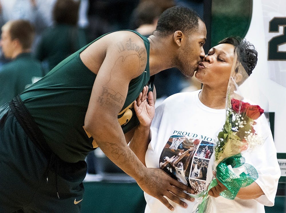 	<p>Senior center Derrick Nix kisses his mother, Darlis Nix, after being honored on Senior Night after the game against Northwestern on Sunday, Mar. 10, 2013, at Breslin Center. Nix scored ten points against the Wildcats. Katie Stiefel/The State News</p>