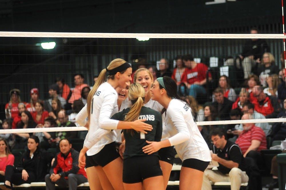 <p>A post score huddle between teammates Nov. 22, 2014 during their game against Rutgers at Jenison Field House. The Spartans defeated the Scarlet Knights, 3-0. Dylan Vowell/The State News</p>