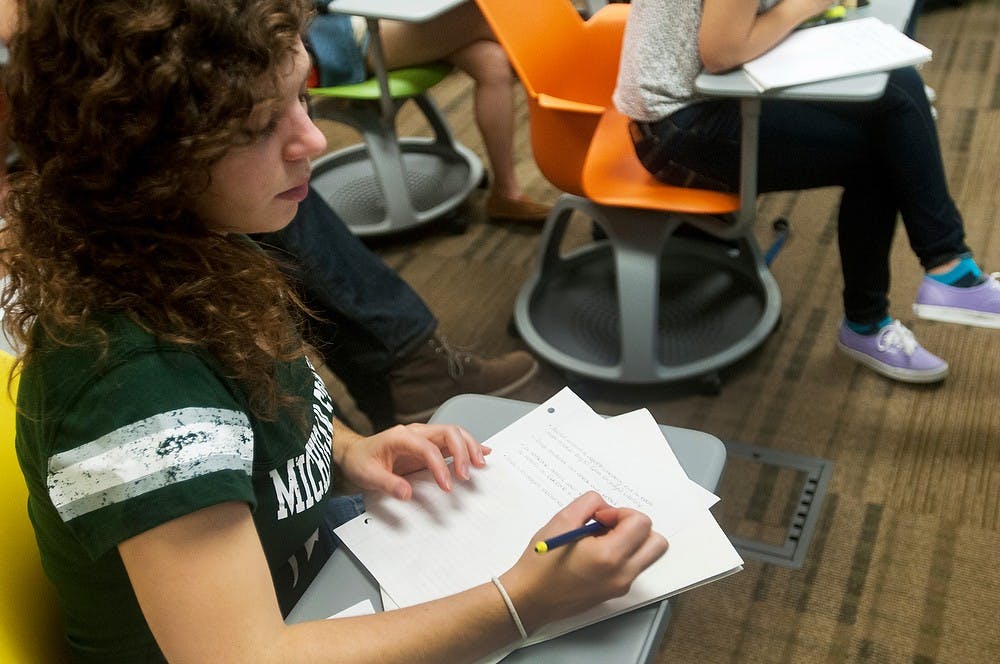 	<p>Social work graduate student Emily Blankenship writes down information given during the Library Bootcamp on Friday, Aug. 30, 2013, at the Main Library. The Library Bootcamp was intended to help students explore the Library&#8217;s resources and services. Katie Stiefel/The State News</p>