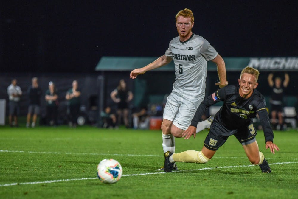 <p>Senior midfielder Michael Pimlott (5) fights for the ball during the game against Western Michigan on Sept. 20, 2019. The Spartans fell to the Broncos, 0-1.</p>