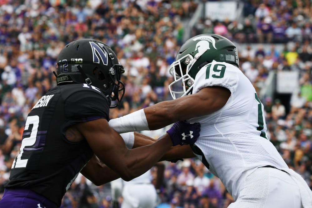 <p>Then-senior cornerback Josh Butler (19) blocks a Northwestern player during the game at Ryan Field on Sept. 21, 2019. MSU defeated Northwestern 31-10.</p>