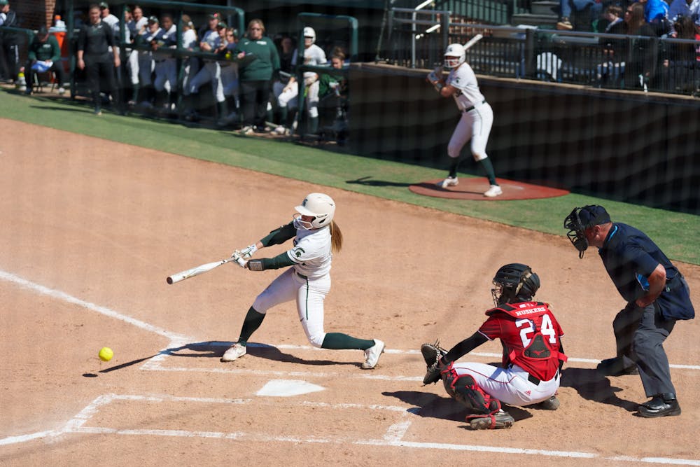 <p>Michigan State senior Courtney Callahan hitting a ground ball in first inning. Spartans lost 5-4 against Nebraska, on April 10, 2022.</p>