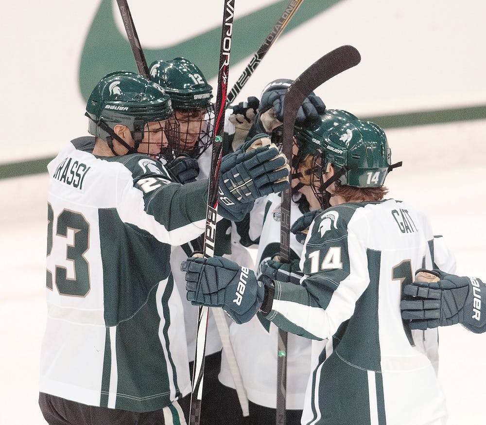 	<p>Spartan teammates celebrate after freshman forward Ryan Keller scored the second goal of the game on Monday night, Oct. 8, 2012, at Munn Ice Arena. <span class="caps">MSU</span> defeated Windsor, 6-1in the first and only exhibition game. Adam Toolin/The State News</p>