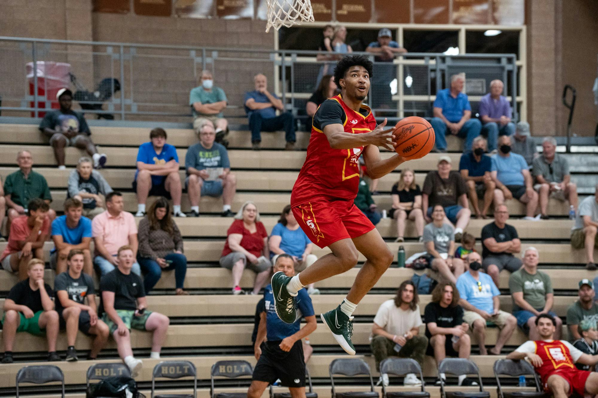 <p>Michigan State sophomore guard Jaden Akins goes up for a dunk during the Moneyball Pro-Am at Holt High School on July 12, 2022.</p>